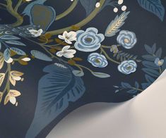 a blue and gold wallpaper with birds on it's branches, flowers and leaves