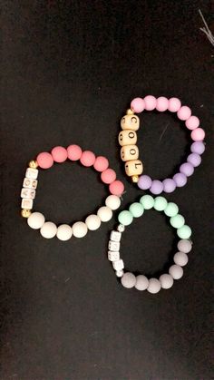 The bracelets are made with a word in the middle and 2 different colored beads! Trendy Bracelets With Letter Beads, Trendy Bracelet With Letter Beads, Trendy Bracelet With Letter And Round Beads, Everyday Beaded Bracelets With Large Beads, Everyday Name Bracelet With Colorful Beads, Friendship Wristband With Letter And Round Beads, Casual Letter Beads For Gifts, Friendship Rosary Bracelet With Letter Beads, Colorful Beads Name Bracelet For Everyday