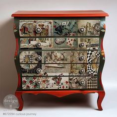 an old dresser with many different designs on the top and bottom drawers, all painted red