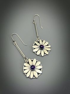 "Sterling silver flower earrings with Purple Amethyst  gemstones. They are made one at a time so each flower is slightly different Sterling silver ear wires. The length of these earrings from the top is 2.7\" The width at the widest point is 1\" These are light to wear. If they're not comfortable on me I won't sell them. Sterling silver setting. 6mm Purple Amethyst  My signature and .925 are on the piece. All my pieces are 100% handmade by me. Each box jewelry is packaged has a special painting Pierced Sterling Silver Flower Earrings, Sterling Silver Flower-shaped Jewelry With Matching Earrings, Handmade Sterling Silver Flower Earrings, Purple Sterling Silver Jewelry With Flower Charm, Sterling Silver Jewelry With Purple Flower Charm, Flower Shaped Gemstone Earrings As Gift, Purple Flower-shaped Nickel-free Jewelry, Purple Nickel-free Flower-shaped Jewelry, Purple Nickel-free Flower Jewelry