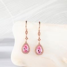 Beautiful drop earrings making for an elegant piece. Each earring is comprised of a highly polished rose gold stud, from which drops a stone set link and a large pear cut pink morganite. The rose gold perfectly accentuates the soft pink of the morganite stone.Carat Weight: 2.37 ctStone Size: 6*9 mmNumber of Stones: 2 Stone Shape: PearStone Color: Fancy PinkCarat Weight: 0.552 ctStone Size: 1.2,1,0.8 mmStone Type: Jeulia® StoneNumber of Stones: 56 Stone Shape: RoundStone Color: Diamond WhiteWeigh Elegant Pink Sterling Silver Teardrop Earrings, Pear-shaped Rose Gold Earrings For Formal Occasions, Rose Gold Pear-shaped Earrings For Formal Occasions, Formal Pear-shaped Rose Gold Earrings, Formal Rose Gold Pear-shaped Earrings, Pink Drop Earrings Fine Jewelry, Rose Gold Briolette Earrings, Fine Jewelry Pink Briolette Earrings, Pink Briolette Fine Jewelry Earrings