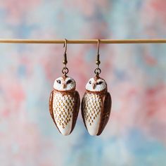 Celebrate the beauty of owls and the charm of nature-inspired jewelry with our Handmade Owl Earrings. Whether you're gifting them to a loved one or indulging yourself, these earrings are a delightful expression of your passion for birds and the whimsy of the animal kingdom. 🦉 Owl Lover's Delight: These owl earrings are a loving tribute to these captivating creatures. They are not just jewelry; they are wearable pieces of owl art that showcase your passion for the animal kingdom. 🎁 Unique Gift: Polymer Clay Owl Earrings, Whimsical Brown Jewelry Gift, Whimsical Brown Jewelry For Gifts, Whimsical Brown Jewelry For Gift, Whimsical Bird Design Earrings For Gift, White Bird-shaped Jewelry Gift, Handmade Nature-inspired Earrings As A Gift For Her, Nature-inspired Single Earring As Gift, Nature-inspired Single Earring As A Gift