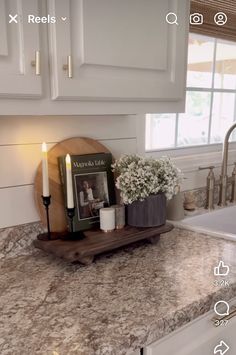 a kitchen counter with candles and pictures on it