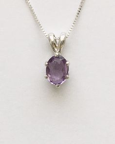 Genuine small oval amethyst measures 7x5mm (3/4 carat) and was handset in sterling silver. Sterling silver box chain is 18 inches long and can be switched out to a 16 inch chain upon request. Necklace is perfect for a child or the minimalist. Comes in a gift box Classic Oval Amethyst Necklaces, Classic Amethyst Oval Pendant Necklace, Oval Lavender Gemstone Necklace, Classic Amethyst Oval Pendant Jewelry, Purple Birthstone Oval Pendant Jewelry, Purple Oval Pendant Birthstone Jewelry, Dainty Sterling Silver Oval Birthstone Necklace, Dainty Oval Sterling Silver Birthstone Necklace, Dainty Oval Purple Jewelry