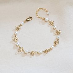 This dainty wire-wrapped pearl bracelet contains beautiful beads wire wrapped on a 14K gold-filled or sterling silver chain. This bracelet makes a great birthday or Christmas gift! Also available in anklet sizes! Measure your wrist or ankle to ensure the proper fit! There are four sizes available. The standard size bracelet has rosary chain of 6 inches with a 1.5 inch extension chain (7.5 inches total - fits wrists from 6 to 7.4 inches). The extended size bracelet has 7.5 inches of rosary chain Cheap Pearl Bracelet For Gifts, Dainty Gold Chain Bracelet With Pearl Charm, Dainty Gold Bracelets With Pearl Chain, Dainty Gold-plated Pearl Chain Bracelet, Pearl Bracelets With Gold Beads As A Gift, Handmade Delicate Pearl Bracelets, Delicate Handmade Pearl Bracelets, Elegant Wire Wrapped Pearl Bracelet, Dainty Gold-plated Bracelets With Pearl Charm