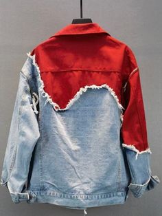 a red and blue jean jacket hanging on a hanger