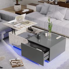 a living room filled with furniture and a laptop computer on top of a coffee table