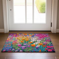 a door mat with flowers painted on it in front of a white door and window