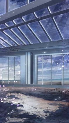 an empty room with lots of windows overlooking the ocean and stars in the night sky