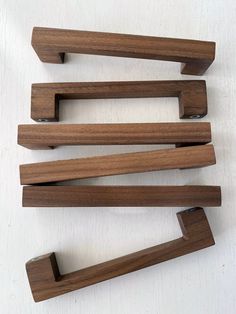 four wooden handles on a white surface