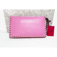 Valentino Garavani Leather Rockstud Flap Clutch In Pink New With Tags - Comes With Dust Bag & Extra Studs Purchased From Nordstrom - March - 2015 Bag Does Have Mark On Front Flap Near Bottom Stud And A Small (Ink?) Dot Underneath Front Flap (See Pictures) I Was Not Comfortable Trying To Do Any Stain Removal. This Rockstud Clutch From Valentino Is Designed In Pink Leather. It Brings An Exterior Enhanced With Rockstud Motifs And A Flap To Secure The Interior. Perfect For A Day Or Evening Look. A S Pink Valentino Wallet, Stain Removal, Valentino Bags, Stain Remover, Pink Leather, Wrist Strap, Flap Pocket, Valentino Garavani, Bags Handbags