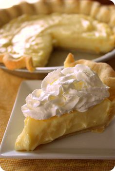 a slice of pie on a plate with whipped cream