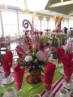 the table is set with candy canes and flowers