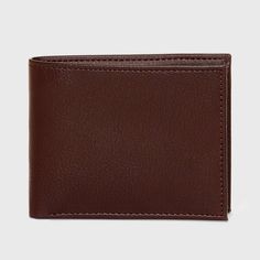 Bring convenience to carrying your money and cards with this Slimfold Wallet from Goodfellow & Co™. This bi-fold wallet features multiple card slots, ID pocket and a bill compartment, while the slimfold design lends it a non-bulky feel, making it easier to slip in the front or rear pockets of your trousers. Best of all, it features RFID blocking that helps prevent your cards and IDs from digital theft. Showcasing a faux-leather finish in brown, it's sure to bring classic style to your everyday a Classic Trifold Wallet With Id Window, Classic Bifold Wallet With Coin Pocket, Classic Bifold Wallet With Rfid Blocking, Classic Trifold Wallet With Coin Pocket, Classic Rectangular Trifold Wallet With Coin Pocket, Classic Bifold Wallet With Card Slots, Classic Bifold Wallet With Interior Card Slots, Modern Brown Bifold Wallet, Leather Finish