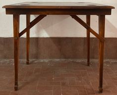 a wooden table sitting on top of a tiled floor