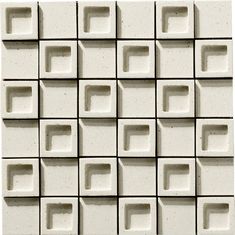 a white tile wall with square and rectangle shapes