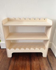 a wooden shelf sitting on top of a hard wood floor