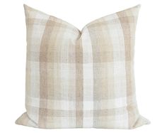 a beige and white plaid pillow on a white background