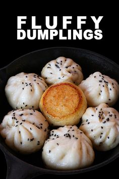 a pan filled with dumplings covered in black sesame seeds and topped with a fried pastry