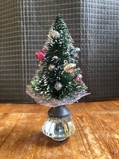 a small christmas tree sitting on top of a wooden table