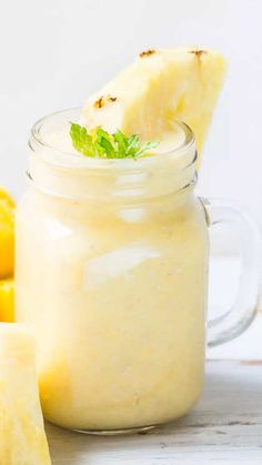 a mason jar filled with lemon curd next to sliced lemons