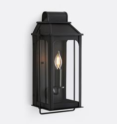 an outdoor wall light with a candle on it