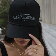 This hat goes out to all of our Charleston lovers! Coming in black and beige, our Charleston Trucker Hat is the perfect accessory for all of those warm, sunny days. For a complete look make sure you get our Charleston Sweatshirt. Want more styles? Shop our full apparel line. Trendy Black Snapback Hat With Curved Brim, Black Brimmed Trucker Hat For Spring, Spring Black Adjustable Snapback Hat, Black Adjustable Snapback Hat For Spring, Black Brimmed Baseball Cap With Letter Print, Black Brimmed Casual Baseball Cap, Black Flat Brim Trucker Hat For Spring, Trendy Black Trucker Hat For Everyday, Black Summer Hat With Letter Print