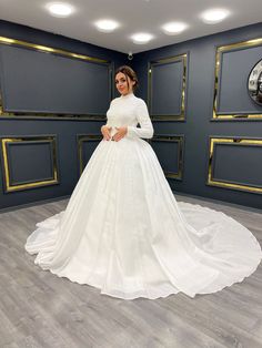 Regal High-Neck Beaded Ball Gown with Long Sleeves and Full Satin Skirt - Larosabride's Exclusive High Neck Wedding Dress With Fitted Bodice, High Neck White Wedding Dress, High Neck White Dress For Wedding, White High Neck Dress For Wedding, Beaded Ball Gown, Gown With Long Sleeves, Dramatic Entrance, Voluminous Skirt, Intricate Beading