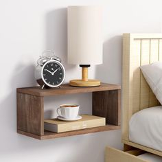 an alarm clock is sitting on a shelf next to a coffee cup and bookcase