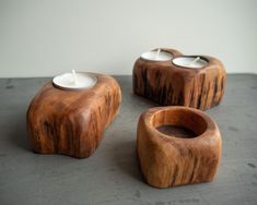 The unique set of 2 wooden candle holders.  Each holder is handcrafted from a solid piece of old oak log. Color, cracks, and ray flecks make these holders one-of-a-kind natural rustic decors. The set is impregnated and protected with natural oils and a beeswax blend. The Set contains: - 1 holder for 2 candles - approx. 6 cm / 2.3 inches in height and 10 cm / 3.9 inches in width. - 1 holder for 1 candle (wider) - approx. 5 cm / 1.9 inches in height and 9 cm / 3.5 in width. - 1 holder for 1 candle Wooden Candle Holders Rustic, T Light Holders, 2 Candles, Rustic Decoration, Sources Of Heat, Oak Logs, Air One, Wooden Candle, Wooden Candle Holders