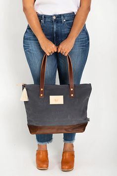 Shop the Slate Blue Wax Canvas Day Tote | Meanwhile in Lynchburg – Meanwhile Back on the Farm Horse Hair Tassels, Wax Canvas, Lynchburg Virginia, Waxed Canvas Bag, Age Gracefully, Dark Denim Jeans, On The Farm, Aging Gracefully, Blue Canvas