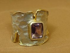 "Photos are enlarged to show detail. All measurements are approximate. Sterling silver rhodium plated ring with gold plated accents set with a genuine purple amethyst (approx 1 1/2 cts) by Juvite. This unique, contemporary, European design ring was hand crafted, and retails for more than $300. Currently a size 7 1/2 on our mandrel (mandrels may differ slightly). This ring doesn't show any wear at all, as you can see from the photos. (The white on the stone is just a spec of dust, and not a scrat Silver Luxury Amethyst Ring With Polished Finish, Luxury Silver Amethyst Ring With Polished Finish, Gold Amethyst Jewelry With Polished Finish, Gold Amethyst Jewelry With Accent Stones, Gold Sterling Silver Fine Jewelry Amethyst Ring, Gold Amethyst Ring In Sterling Silver Fine Jewelry, Gold Amethyst Ring In Sterling Silver, Handmade Gold Amethyst Ring For Formal Occasions, Gold Amethyst Ring With Gemstone Accents In Sterling Silver