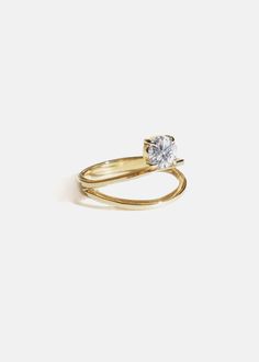 a yellow gold ring with a single diamond