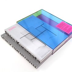 three books stacked on top of each other with sticky notes attached to the covers in different colors