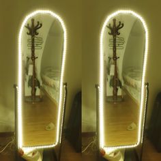 two mirrors that have lights on them in the shape of trees, and one has a bed behind it