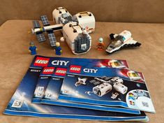 three lego city sets are on the couch next to each other, including an airplane and space shuttle