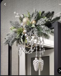 a chandelier hanging from the side of a door with christmas decorations on it