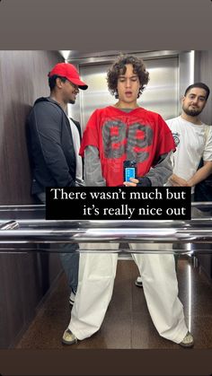 two men standing next to each other in an elevator