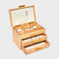 an open wooden box with jewelry inside