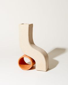 a white and orange sculpture sitting on top of a table