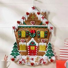 an advertisement for a christmas gingerbread house with decorations on the front and side of it