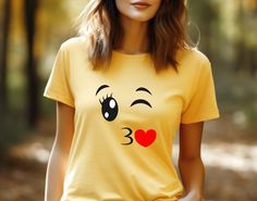 Show off your Halloween spirit with a fun, custom Trendy Custom Apparel Emoji Group Costume T-Shirt! This unisex t-shirt comes in daisy yellow, a bright and classic color combination- perfect for spooky season! It is made of 100% soft cotton featuring bright soft flex vinyl colors and a Gildan pre-shrunk brands for your best comfort and style. Whether you're dressing up your entire family with a matching emoji look, or just looking for a casual and cozy Halloween-themed shirt, this t-shirt is pe Funny Yellow Pre-shrunk T-shirt, Yellow Funny Print T-shirt, Yellow T-shirt With Funny Print, Yellow Crew Neck T-shirt With Cartoon Print, Funny Yellow Short Sleeve Tops, Funny Yellow Crew Neck Top, Fun Yellow Tops With Funny Print, Funny Yellow Graphic Print Top, Yellow T-shirt With Character Print