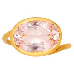 This delicate ring by Scrives is composed of a large Morganite (pink beryl) of 6.2 cts. This design allows light to come into the stone from multiple directions and put into highlight the stone. This ring design has been conceived to be worn adding with 2 or 3 rings together. The ring exists in different shapes of stones and with different kind of stones and can be made on order. The stone is a natural morganite with bright sparkle. Morganite are pink beryl. This one-of-a-kind ring is handmade w Luxury Pink Oval Topaz Ring, Classic Pink Oval Topaz Ring, Yellow Gold Oval Morganite Sapphire Ring, Luxury Oval Solitaire Topaz Ring, Oval Kunzite Ring For Anniversary, Luxury Oval Faceted Topaz Ring, Luxury Faceted Oval Topaz Ring, Oval Morganite Solitaire Ring, Solitaire Morganite Oval Ring