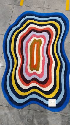 a multicolored area rug on the ground