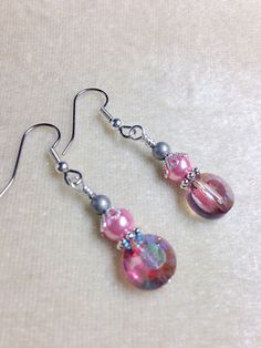 Handmade earrings designed to put a smile on your face every time you put them on. Made using surgical steel ear wires I use wrapped loops to give a finished look. Earrings come with rubber ear backs that slide on to keep earrings from falling out of ears. Color: Antique silver, pink glass pearl, pink glass crystal YOU MAY ALSO LIKE: https://www.etsy.com/shop/JillsHandmadeStuff?search_query=pink+earrings {SHIPPING NOTE} All items are handmade with care after your order is placed. CURRENT ORDER P Jewelry 2022, Pink Crystal Earrings, Beaded Earring, Pearl Pink, Gift For Girlfriend, Pink Earrings, Wire Earrings, Pink Glass, Mom Birthday Gift