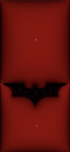 a bat flying through the air on top of a red wall with stars in the background