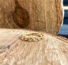 a gold ring sitting on top of a wooden table