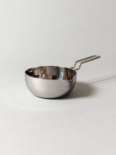 a stainless steel pan with a handle on a white background