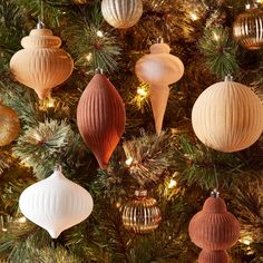 christmas ornaments hanging from the top of a tree in gold, white and red colors