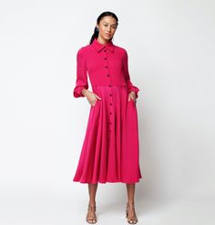 The any occasion dress, refined and at the ready! Our gorgeous, fuchsia-colored seersucker shirtdress is punctuated by navy-colored satin buttons all the way down the front. The flexible fabric makes for an easy fit, and the long sleeves have a looser cut. The mid-length skirt has quite a bit of volume so it sways with every step.  
     100% silk, fully lined bodice.     Made in London. Dry clean only. Allow 2 weeks for delivery. Button-up Silk Evening Dress, Silk Button-up Evening Dress, Formal Pleated Pink Midi Dress, Formal Pink Pleated Midi Dress, Formal Silk Button-up Dress, Formal Button-up Silk Dress, Silk Button-up Dresses For Daywear, Pink Buttoned Midi Dress For Party, Silk Button-up Dress For Semi-formal Occasions